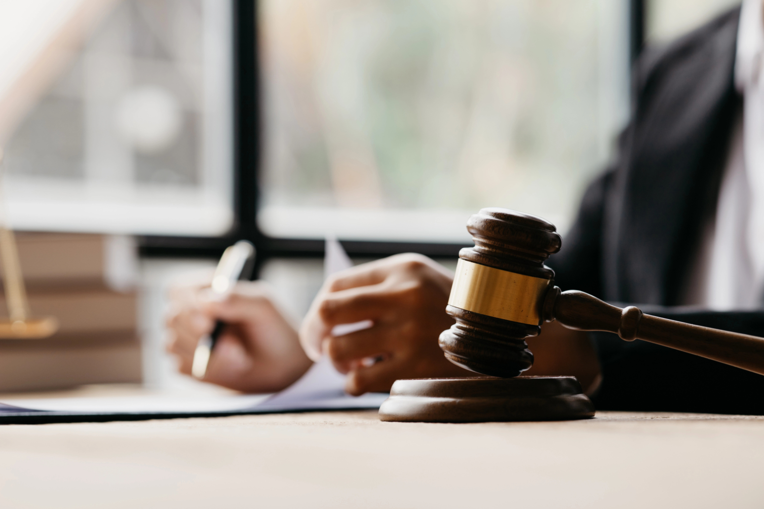 Close-up of a judge's gavel on a desk, symbolizing legal authority.
